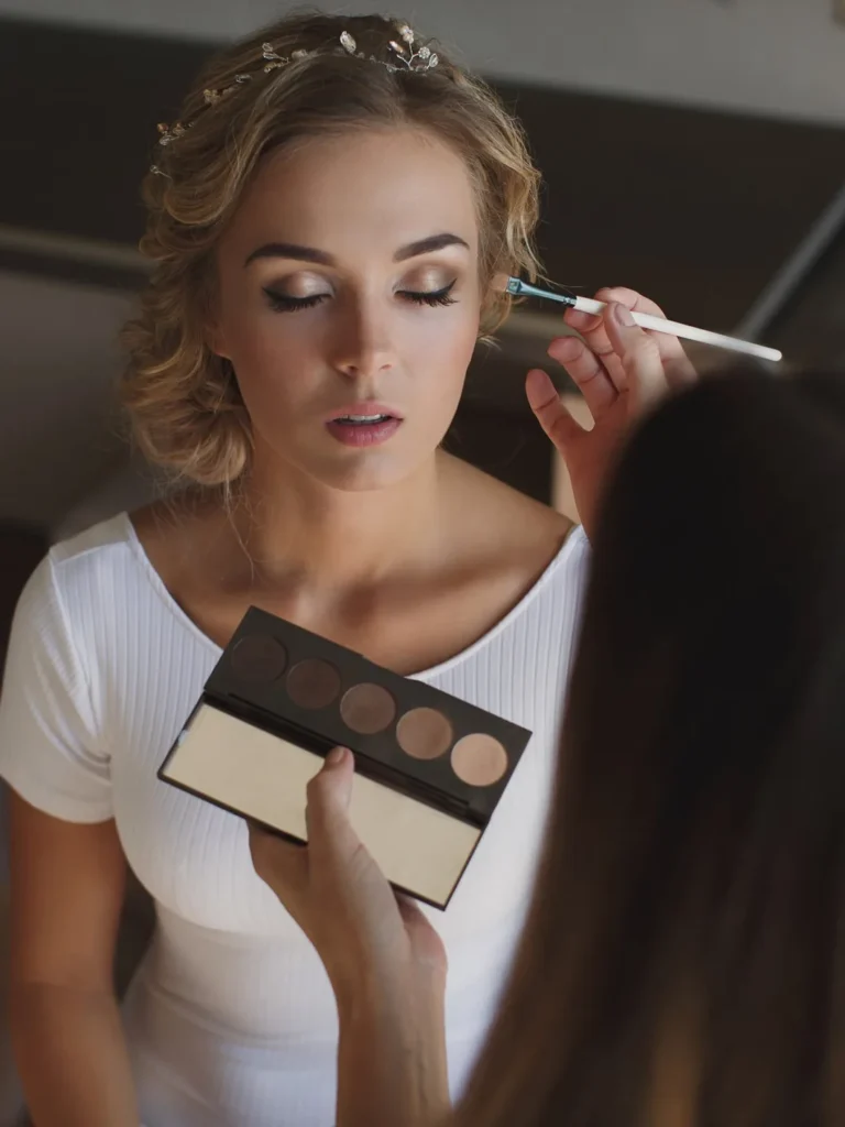 Bride having wedding-day makeup applied during a bridal trial at Jacqui's Design Group, Arlington MA
